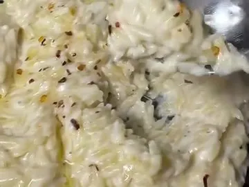Creamy orzo in a pot with a spoon