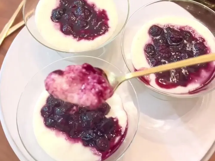 Bowls of farina porridge topped with dark berry syrup