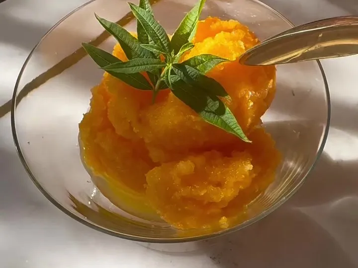Scoops of orange clementine sorbet in a glass dish